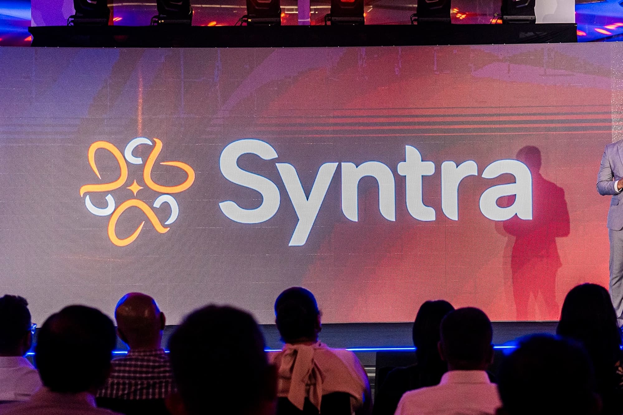 Syntra logo revealed on stage at MiHCM Connect 2025